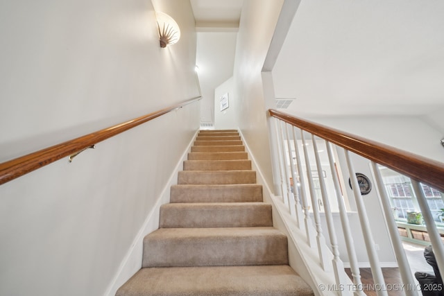 stairs featuring baseboards, visible vents, and carpet floors