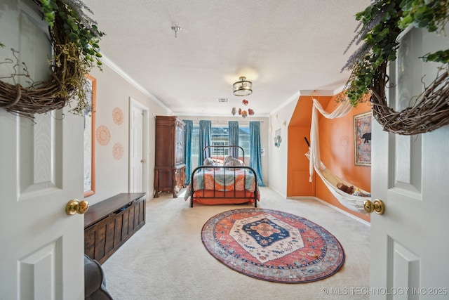 carpeted bedroom featuring a textured ceiling and ornamental molding