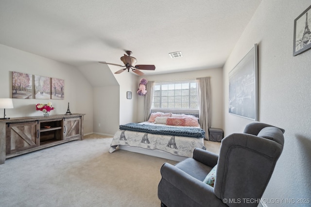 carpeted bedroom with visible vents, baseboards, lofted ceiling, a textured ceiling, and a ceiling fan