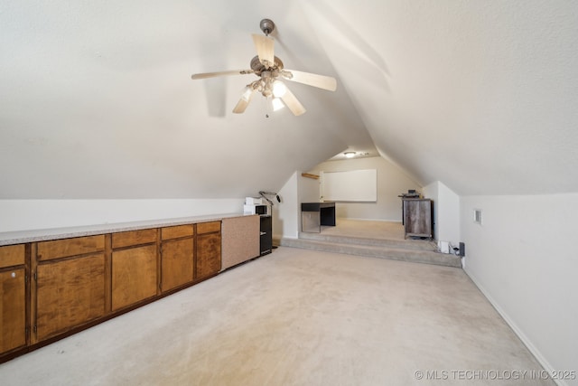 bonus room featuring light carpet, visible vents, ceiling fan, and vaulted ceiling