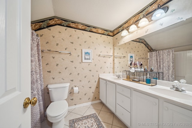 full bathroom featuring a sink, toilet, tile patterned floors, and wallpapered walls