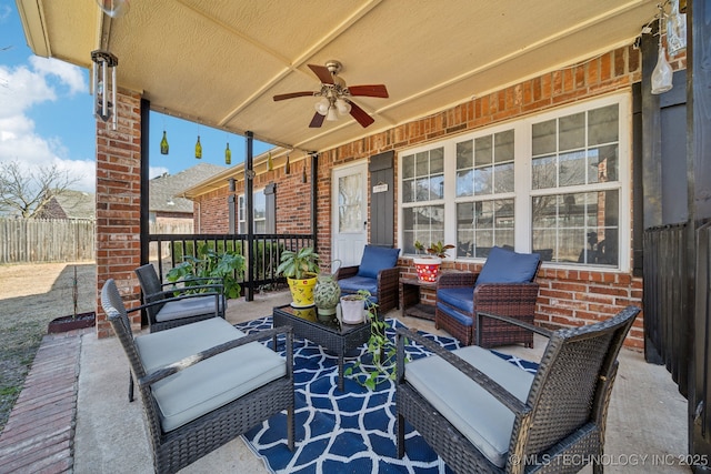 view of patio featuring outdoor lounge area, ceiling fan, and fence