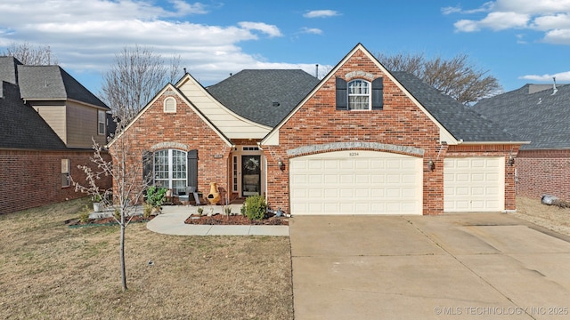 traditional-style home with brick siding, a garage, driveway, and roof with shingles