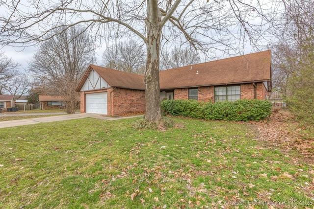 view of front of home with brick siding, driveway, a shingled roof, and a front yard