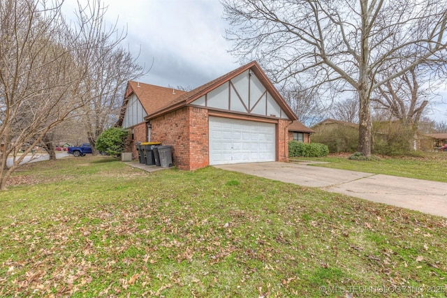 view of side of home with brick siding, driveway, an attached garage, and a yard