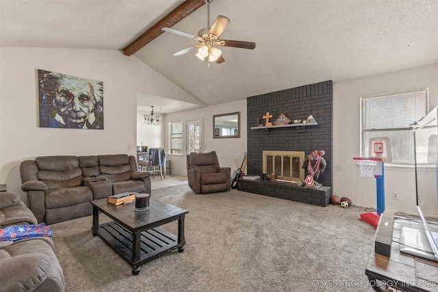 living area with ceiling fan with notable chandelier, lofted ceiling with beams, a textured ceiling, carpet, and a brick fireplace