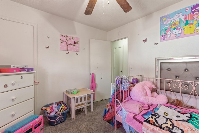 carpeted bedroom with a ceiling fan and a textured ceiling