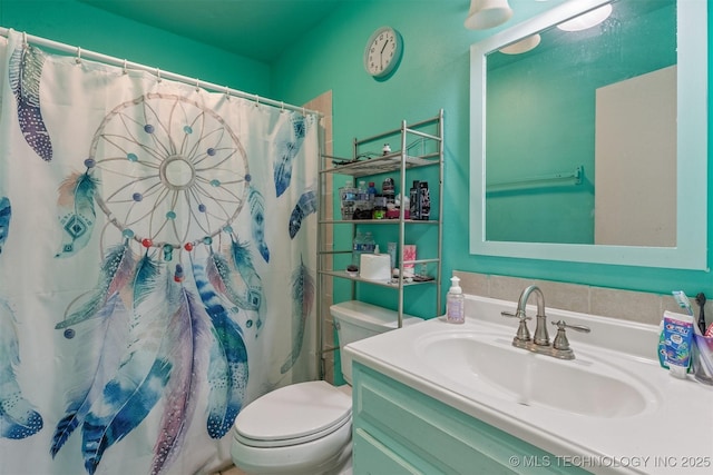 bathroom featuring curtained shower, toilet, and vanity