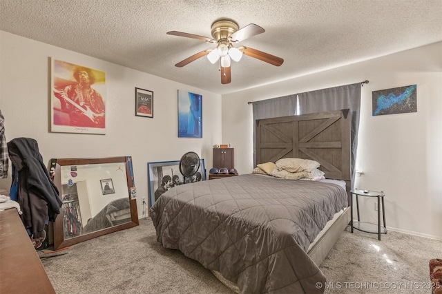 bedroom with carpet flooring, a ceiling fan, baseboards, and a textured ceiling