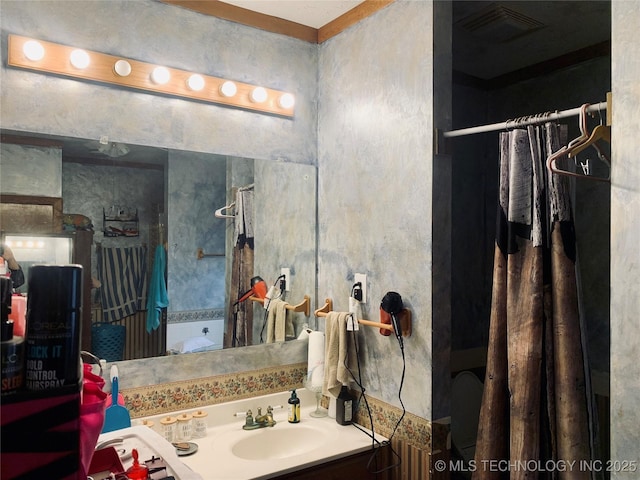 full bathroom featuring vanity, visible vents, and walk in shower