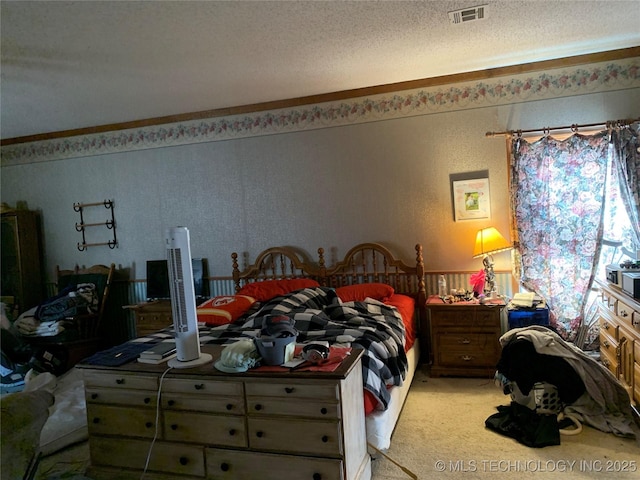 bedroom with visible vents, a textured ceiling, and light colored carpet