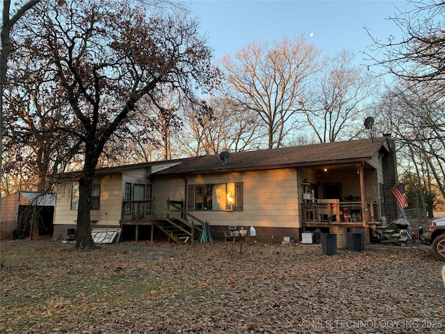 rear view of property with crawl space