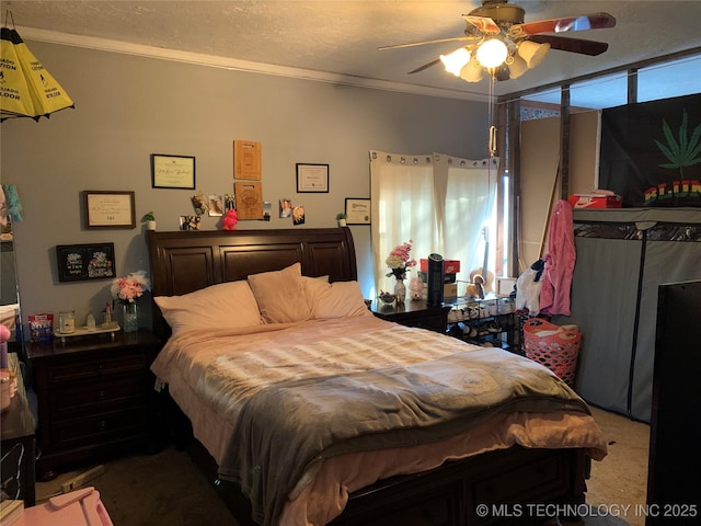 carpeted bedroom featuring multiple windows, a textured ceiling, a ceiling fan, and ornamental molding