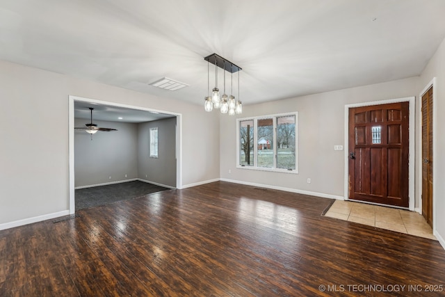 entrance foyer featuring visible vents, wood-type flooring, baseboards, and ceiling fan with notable chandelier