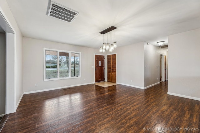 interior space featuring wood finished floors, visible vents, and baseboards