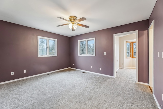 unfurnished room featuring visible vents, baseboards, and carpet