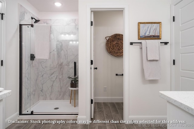 full bathroom with a marble finish shower, vanity, and wood tiled floor