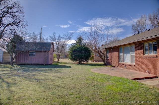 view of yard with an outbuilding, a shed, and a patio