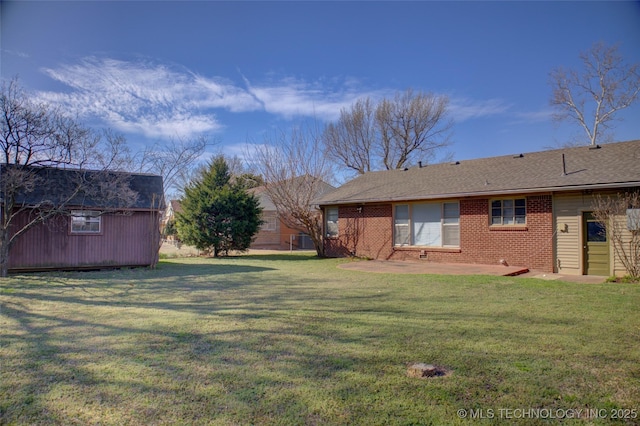 view of yard with a patio, a storage unit, and an outdoor structure