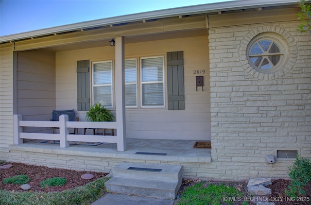 doorway to property featuring crawl space and a porch