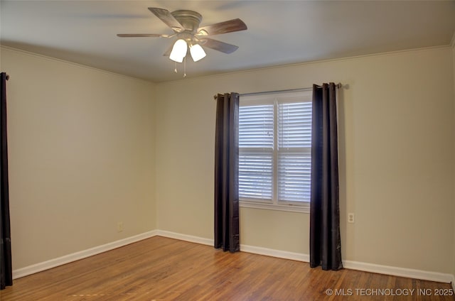 empty room featuring ceiling fan, baseboards, plenty of natural light, and wood finished floors