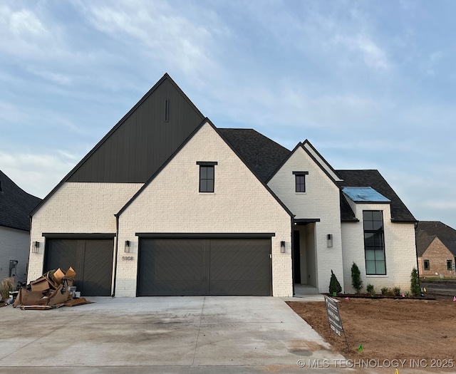 5908 E 127th St S, Tulsa, OK 74008 - view of front of home with brick siding, concrete driveway, a shingled roof, and an attached garage