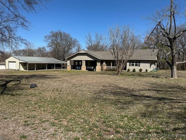 ranch-style home with a detached garage