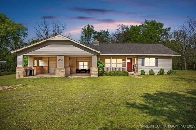 exterior space with a front yard, covered porch, and a chimney