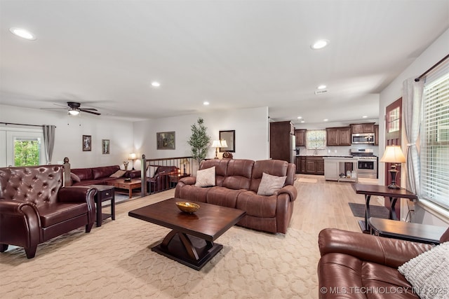 living area with a ceiling fan, recessed lighting, and light wood finished floors