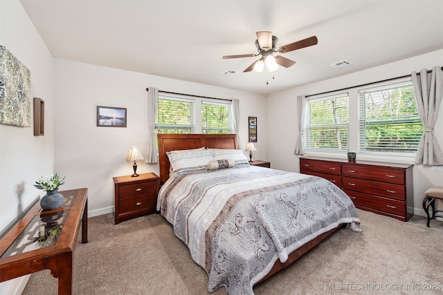 bedroom with visible vents, light colored carpet, and baseboards