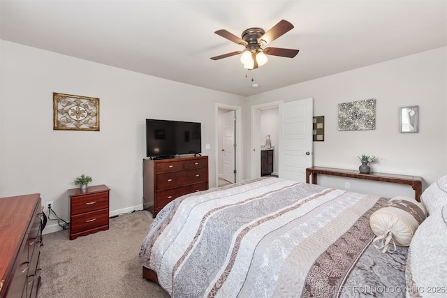 bedroom with light colored carpet, baseboards, and a ceiling fan
