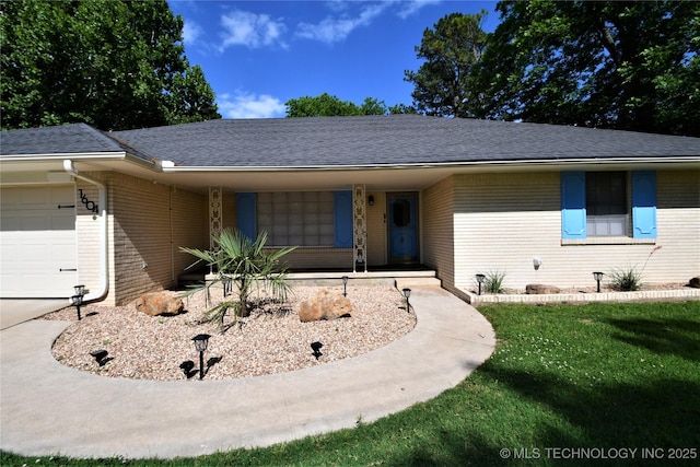 view of front of home featuring a front yard, a garage, brick siding, and a shingled roof