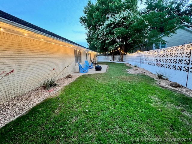 view of yard featuring a patio and a fenced backyard