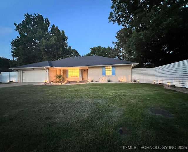 single story home featuring a front lawn, fence, and a garage