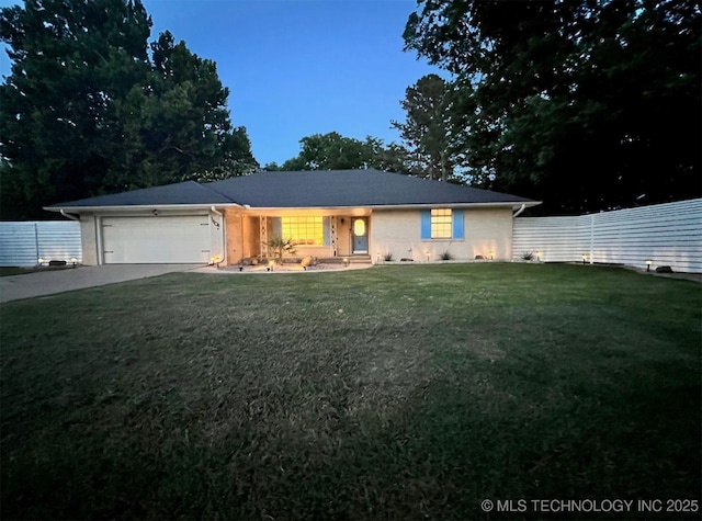 single story home with a garage, driveway, a front yard, and fence