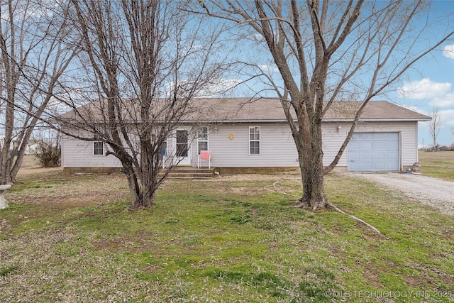 single story home featuring a front yard, a garage, and driveway