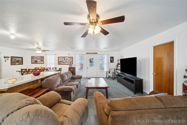 carpeted living room featuring a ceiling fan