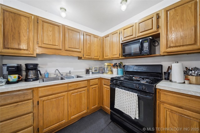 kitchen with a sink, black appliances, brown cabinetry, and light countertops