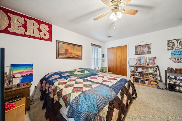 carpeted bedroom featuring a closet, visible vents, and ceiling fan