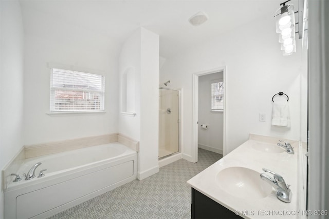 full bathroom with a sink, a stall shower, double vanity, and a bath