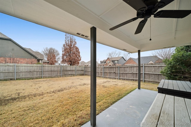 view of yard with a patio area, ceiling fan, and a fenced backyard