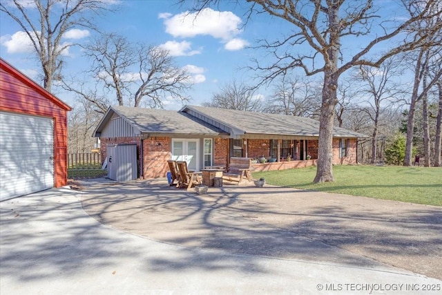 341 S Diamondhead Dr, Burneyville, OK 73430 - view of front of house with board and batten siding, a front yard, and brick siding
