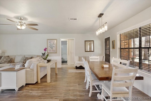 341 S Diamondhead Dr, Burneyville, OK 73430 - dining room featuring visible vents, wood finished floors, and ceiling fan with notable chandelier