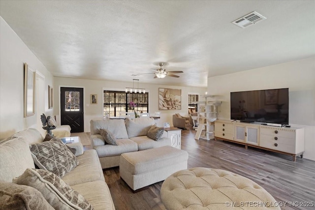 341 S Diamondhead Dr, Burneyville, OK 73430 - living area featuring visible vents, a textured ceiling, ceiling fan, and wood finished floors