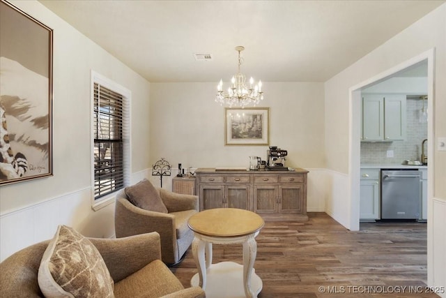 341 S Diamondhead Dr, Burneyville, OK 73430 - living area featuring visible vents, an inviting chandelier, wood finished floors, and wainscoting