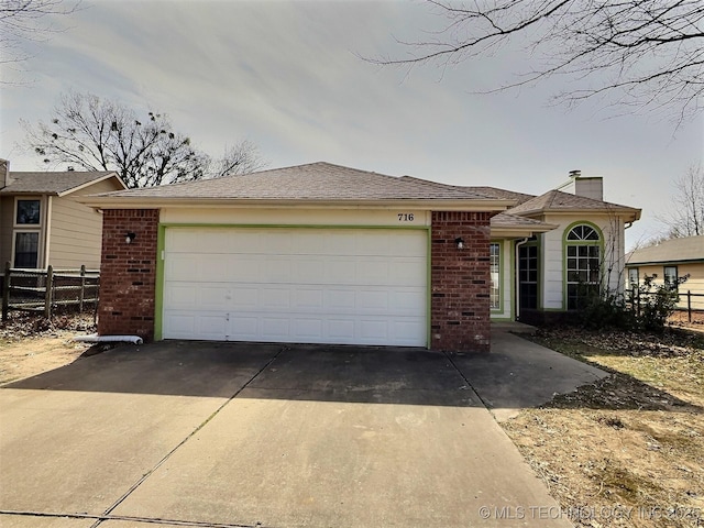 ranch-style home with brick siding, driveway, and fence