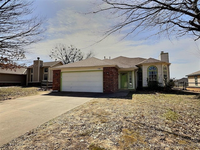 view of front of property with fence, a chimney, concrete driveway, a garage, and brick siding