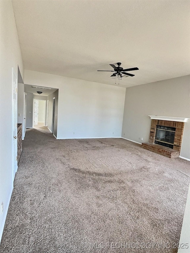 unfurnished living room with a brick fireplace, ceiling fan, and carpet floors