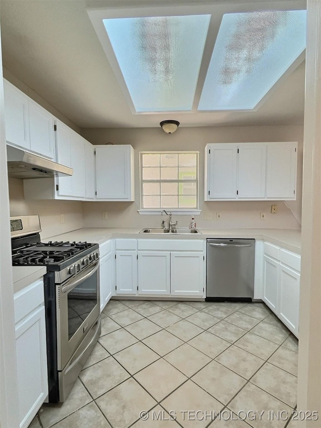 kitchen with a sink, light countertops, under cabinet range hood, and stainless steel appliances