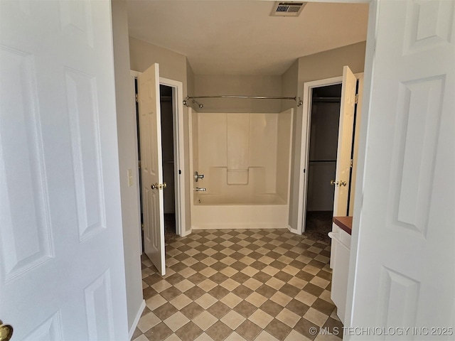 hallway with visible vents and light floors